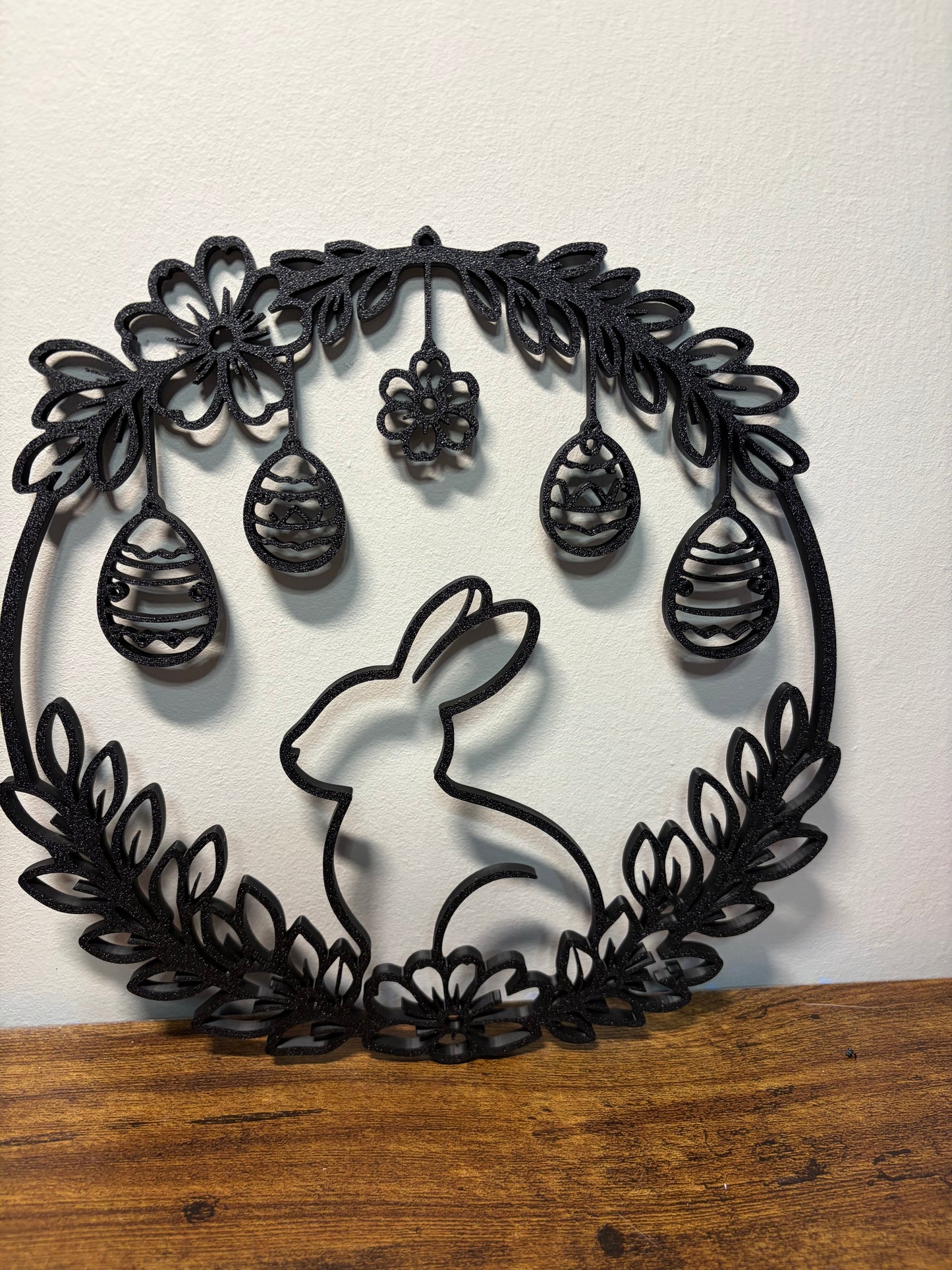 Decorative wall art with a rabbit and floral design on a white background.