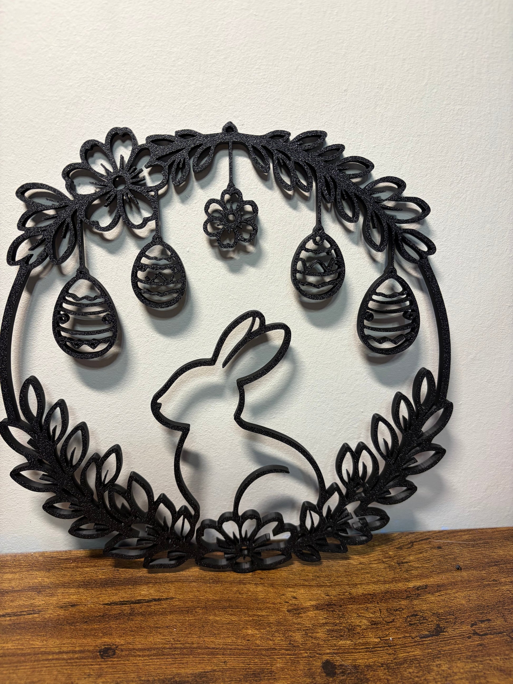 Decorative wall art with a rabbit and floral design on a white background.