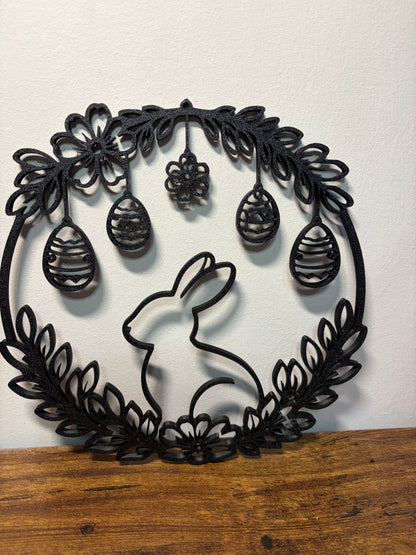 Decorative wall art with a rabbit and floral design on a white background.